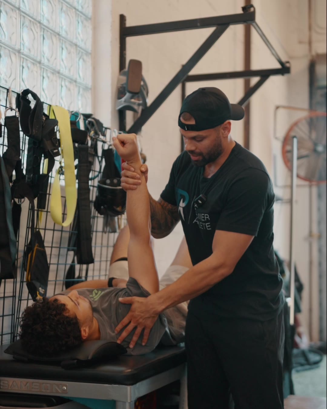 Dr. Evan Motlong treating an athlete's shoulder