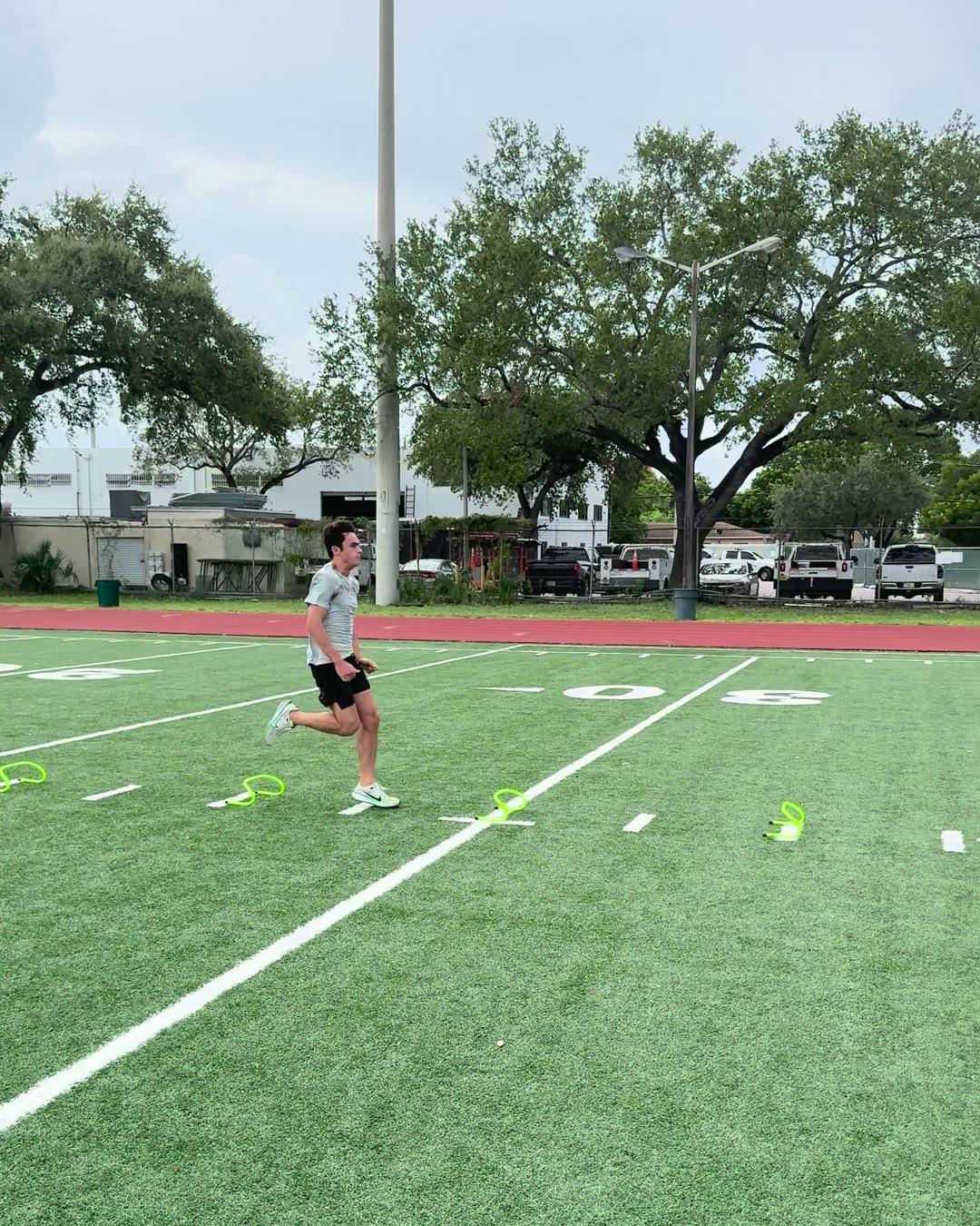 Athlete sprinting through wickets on a turf field